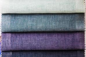 Detailed close up view on samples of cloth and fabrics in different colors found at a fabrics market photo