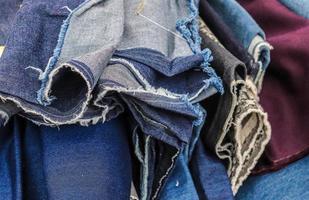 Detailed close up view on samples of cloth and fabrics in different colors found at a fabrics market photo