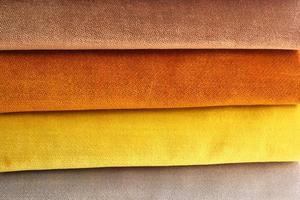 Detailed close up view on samples of cloth and fabrics in different colors found at a fabrics market photo
