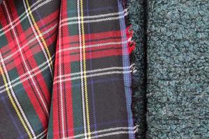 Detailed close up view on samples of cloth and fabrics in different colors found at a fabrics market photo