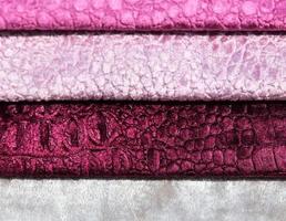 Detailed close up view on samples of cloth and fabrics in different colors found at a fabrics market photo