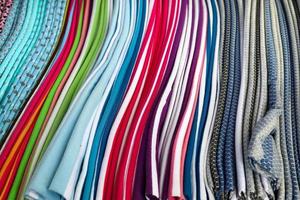 Detailed close up view on samples of cloth and fabrics in different colors found at a fabrics market photo