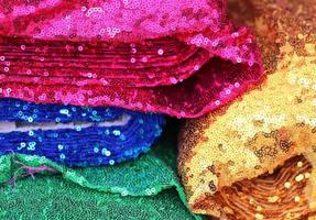 Detailed close up view on samples of cloth and fabrics in different colors found at a fabrics market photo