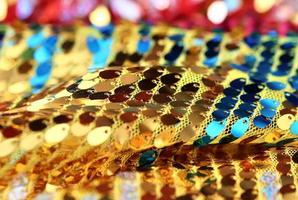 Detailed close up view on samples of cloth and fabrics in different colors found at a fabrics market photo