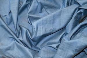 Detailed close up view on samples of cloth and fabrics in different colors found at a fabrics market photo