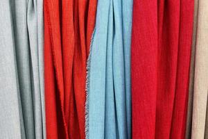Detailed close up view on samples of cloth and fabrics in different colors found at a fabrics market photo