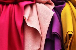 Detailed close up view on samples of cloth and fabrics in different colors found at a fabrics market photo