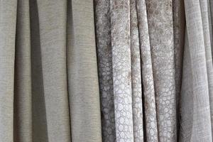 Detailed close up view on samples of cloth and fabrics in different colors found at a fabrics market photo