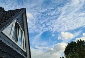 Open roof window in velux style with black roof tiles. photo