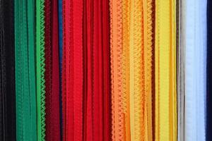 Detailed close up view on samples of cloth and fabrics in different colors found at a fabrics market photo