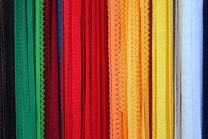 Detailed close up view on samples of cloth and fabrics in different colors found at a fabrics market photo