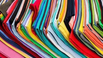 Detailed close up view on samples of cloth and fabrics in different colors found at a fabrics market photo