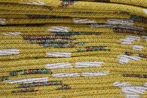 Detailed close up view on samples of cloth and fabrics in different colors found at a fabrics market photo