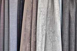 Detailed close up view on samples of cloth and fabrics in different colors found at a fabrics market photo