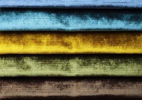 Detailed close up view on samples of cloth and fabrics in different colors found at a fabrics market photo