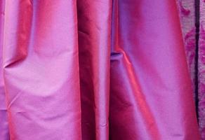 Detailed close up view on samples of cloth and fabrics in different colors found at a fabrics market photo