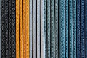 Detailed close up view on samples of cloth and fabrics in different colors found at a fabrics market photo
