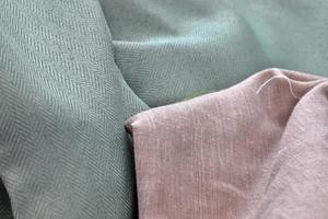 Detailed close up view on samples of cloth and fabrics in different colors found at a fabrics market photo