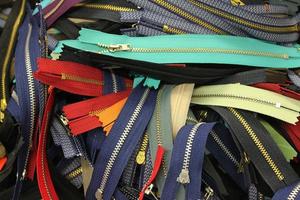 Detailed close up view on samples of cloth and fabrics in different colors found at a fabrics market photo