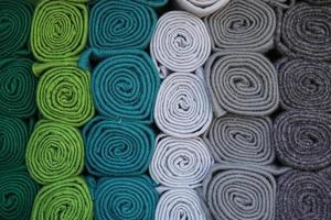 Detailed close up view on samples of cloth and fabrics in different colors found at a fabrics market photo