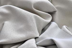 Detailed close up view on samples of cloth and fabrics in different colors found at a fabrics market photo