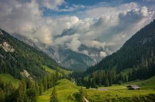 clouds around peaks of Reither Alpe mountains with Bindalm in the front, Berchtesgaden national park, Bavaria, Germany photo