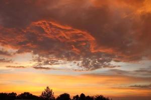 Beautiful orange and yellow clouds at sunrise and sunset in the sky. photo