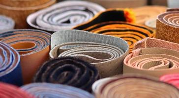 Detailed close up view on samples of cloth and fabrics in different colors found at a fabrics market photo