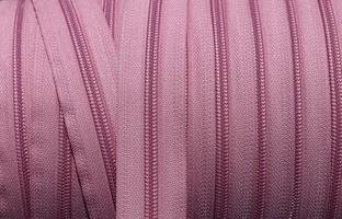 Detailed close up view on samples of cloth and fabrics in different colors found at a fabrics market photo