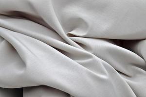 Detailed close up view on samples of cloth and fabrics in different colors found at a fabrics market photo