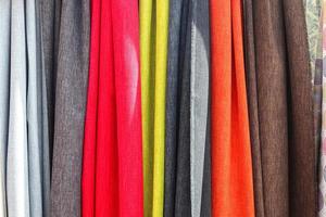 Detailed close up view on samples of cloth and fabrics in different colors found at a fabrics market photo