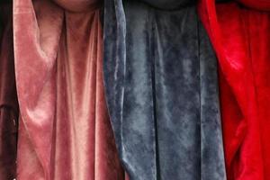 Detailed close up view on samples of cloth and fabrics in different colors found at a fabrics market photo