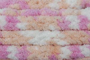 Hand made crochet pattern of a colorful sheep wool yarn for background. photo