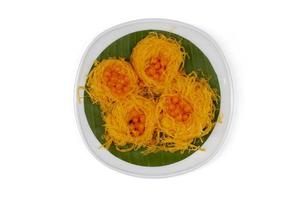 Top view of Thai dessert Golden Egg yolk threads and Golden drop Thai people call Foi Thong and Thong Yot in white plate isolated on white background included clipping path. photo