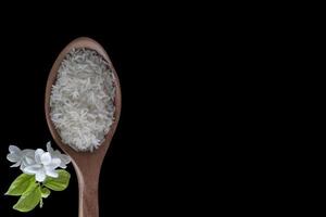 Top view of Jasmine rice is famous rice in Thailand isolated on black background included clipping path. photo