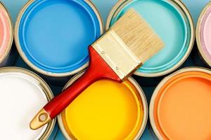 Paint cans and paint brushes and how to choose the perfect interior paint color and good for health photo