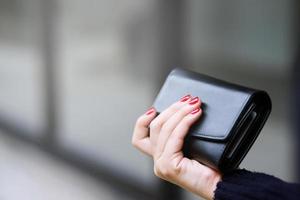 woman person holding a wallet in the hand. Cost control expenses shopping in concept. Leave space to write descriptive text. photo