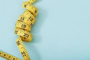 tape measure for obese people on a blue background photo