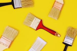 Paint brush on yellow background, how to choose the perfect home paint color and good for health photo