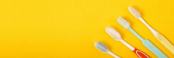 old toothbrush on yellow background photo
