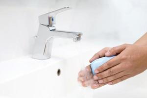 Hygiene. Cleaning Hands. Washing hands with soap under the faucet with water Pay dirt. photo