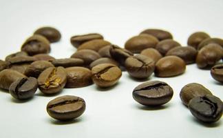 The way coffee beans lay on a white background, elegant and delicious coffee beans and the aroma of morning coffee. photo