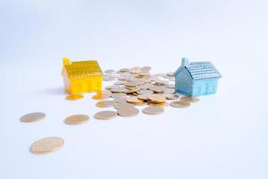 House model and coins money investments, loans and real estate concept photo