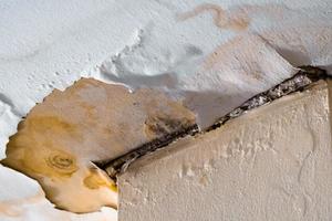 Water damaged ceiling roof, brown stain, office building photo