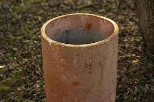 Stone garbage bin. Concrete cylinder for waste. photo