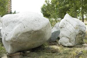 Two large gray boulders close-up in the city park. The texture of the stone, the decorative design of parks in Russia. Outdoor shooting. photo