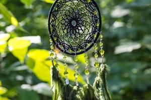 Handmade dream catcher with feathers threads and beads rope hanging photo