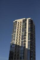 Residential building in city. House with windows and balconies. photo