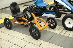 Children's transport in the park. Machines on a mechanical course. Entertaining bicycles for hire. photo