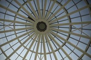 Dome roof made of glass and fittings. Steel beams form circle. photo